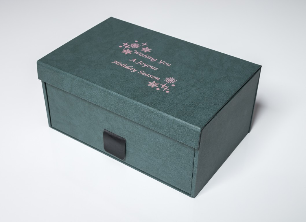 Green gift box with holiday season message.