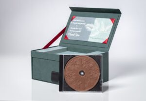 Green box with a decorative chocolate disc.