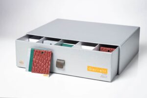 Gray storage box with organized fabric samples.