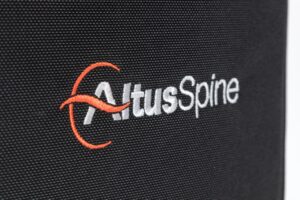 Logo with "AltusSpine" text on fabric.