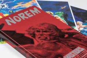 Red Norem book with illustrated posters behind.