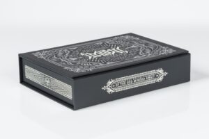 Decorative black box with intricate white design.