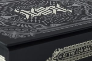 Decorative black box with intricate white patterns.