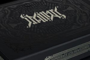 Decorative black box with intricate white lettering.