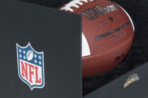 NFL-branded Wilson football in display box.