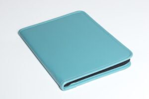 Teal leather binder on white background.