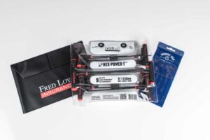 Tools and insurance envelope on white background.