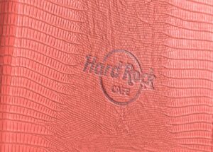 Red textured surface with embossed logo.
