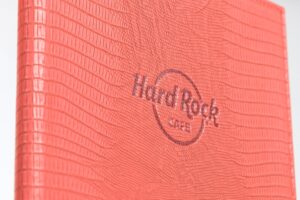 Red textured Hard Rock Cafe menu cover.