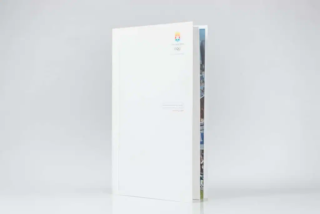 White book standing upright on surface.