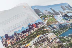 Open magazine with cityscape images inside.