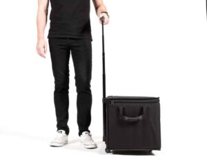 Person with rolling black suitcase on wheels.