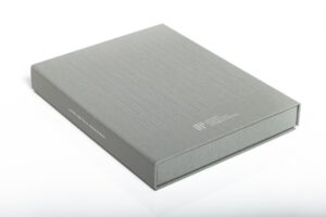 Gray hardcover book with subtle branding text.