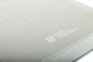 Gray book with embossed text logo.