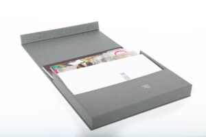 Gray document folder with booklets inside.