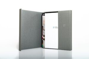 Gray folder with documents partially visible.