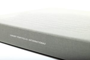 Gray book titled "Luxury Portfolio International".