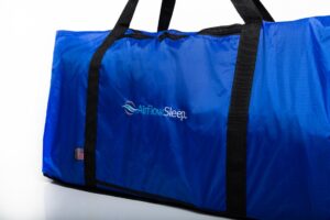Blue duffel bag with black straps.